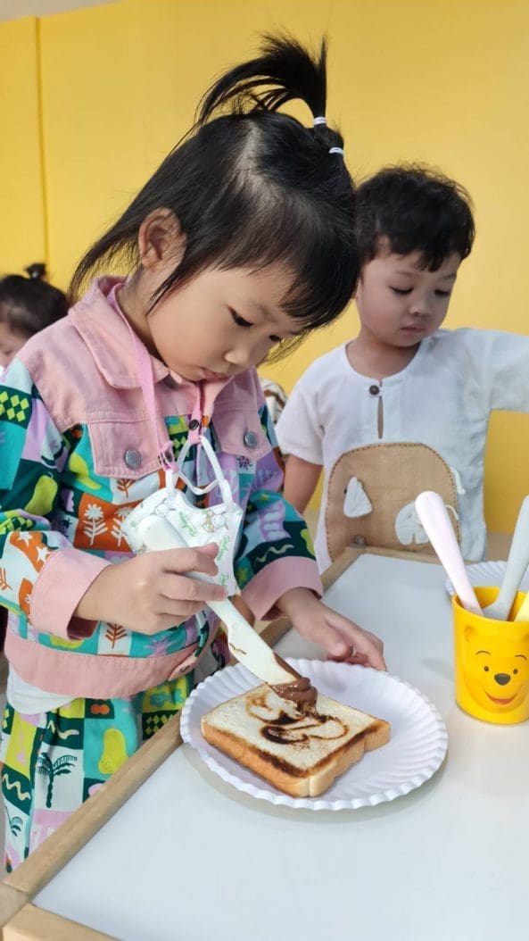 Child practicing life skills at KidAble Montessori-certified school.